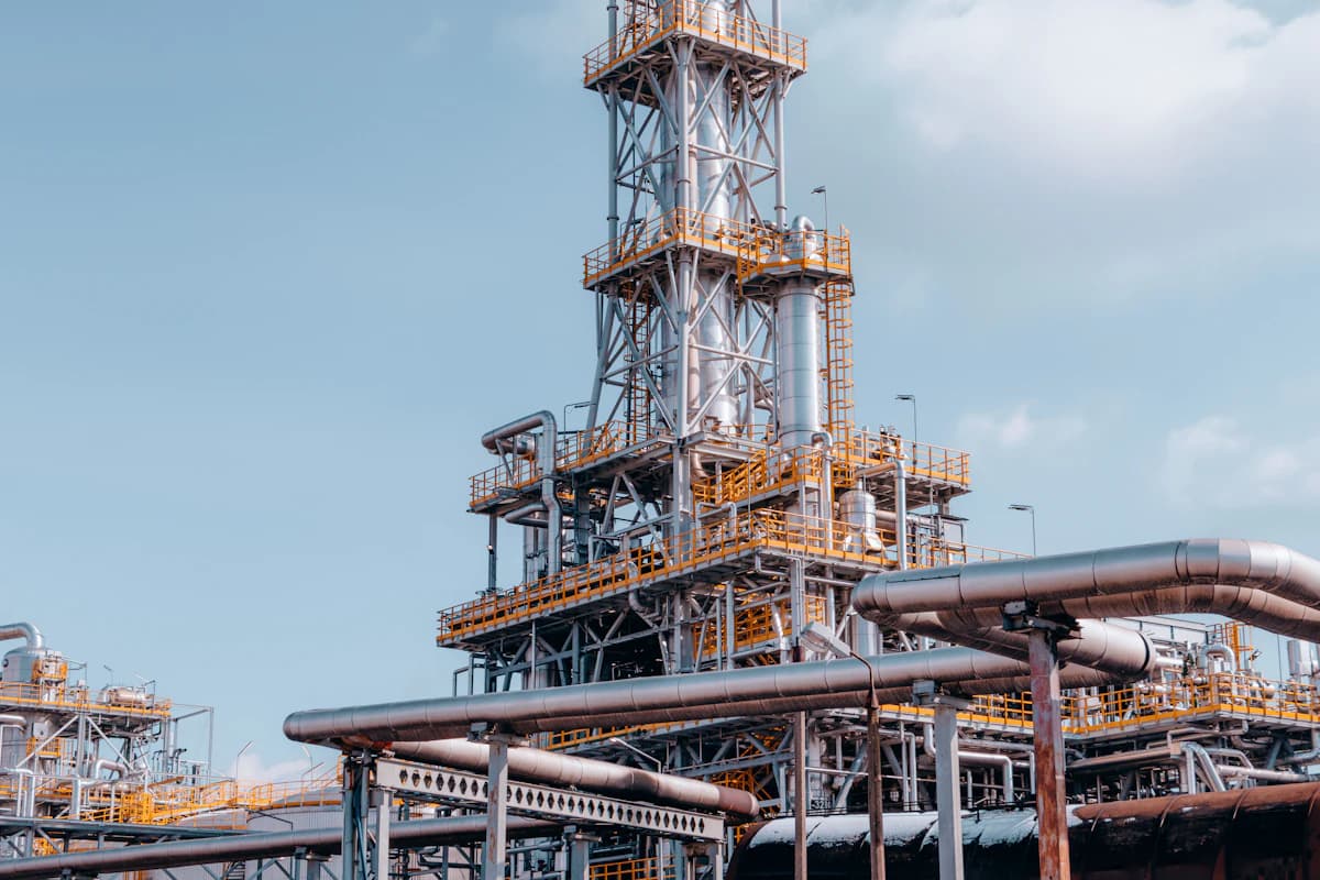 A processing unit with insulated pipe racks and yellow railings